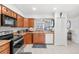 Well-equipped kitchen with wood cabinets and appliances at 4522 Brook Hollow Cir, Winter Springs, FL 32708