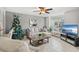 Bright living room with comfy seating, large TV, and a Christmas tree at 4522 Brook Hollow Cir, Winter Springs, FL 32708