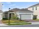 House exterior showcasing a two-car garage and landscaping at 6886 Wilson Hammock Ave, Groveland, FL 34736