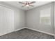 Simple bedroom with carpet, double door closet, and window coverings at 6886 Wilson Hammock Ave, Groveland, FL 34736
