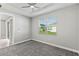 Simple bedroom with gray carpet and a window with blinds at 6886 Wilson Hammock Ave, Groveland, FL 34736