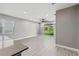 Spacious living room featuring tile floors and access to backyard at 6886 Wilson Hammock Ave, Groveland, FL 34736