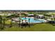 Aerial view of community pool, playground, and clubhouse at 6886 Wilson Hammock Ave, Groveland, FL 34736