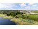 Community lakefront view with walking paths and new homes at 6886 Wilson Hammock Ave, Groveland, FL 34736