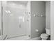 Clean bathroom with a walk-in shower and gray walls at 6886 Wilson Hammock Ave, Groveland, FL 34736