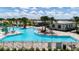 Community pool with a clubhouse and surrounding patio furniture at 6886 Wilson Hammock Ave, Groveland, FL 34736