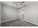 Cozy bedroom with gray carpet and access to bathroom at 6886 Wilson Hammock Ave, Groveland, FL 34736