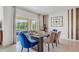 Elegant dining room with glass table and blue velvet chairs at 7117 Painted Bunting Way, Saint Cloud, FL 34773