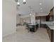 Open kitchen with island, stainless steel appliances, and dark wood cabinetry at 1142 Trappers Trail Loop, Davenport, FL 33896