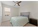 Bright bedroom with a queen-size bed and ceiling fan at 1142 Trappers Trail Loop, Davenport, FL 33896