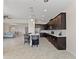 Modern kitchen with dark cabinets, quartz countertops and stainless steel appliances at 1142 Trappers Trail Loop, Davenport, FL 33896