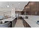Well-equipped kitchen featuring dark cabinetry and expansive countertops at 1142 Trappers Trail Loop, Davenport, FL 33896