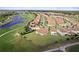 Aerial view of house, golf course, and pond at 1142 Trappers Trail Loop, Davenport, FL 33896