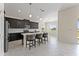 Contemporary kitchen boasts dark cabinetry, quartz countertops, and breakfast bar at 1142 Trappers Trail Loop, Davenport, FL 33896