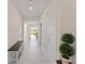 Bright and spacious entryway with tile flooring and a wooden bench at 1142 Trappers Trail Loop, Davenport, FL 33896