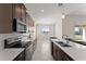 Modern kitchen with dark cabinets, white quartz countertops and stainless steel appliances at 1142 Trappers Trail Loop, Davenport, FL 33896