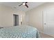 Bedroom with a queen bed, ceiling fan, and access to hallway at 1142 Trappers Trail Loop, Davenport, FL 33896