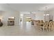 Open living room and dining area with tile floors and large windows at 1142 Trappers Trail Loop, Davenport, FL 33896
