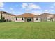 Large backyard with grassy lawn at 1142 Trappers Trail Loop, Davenport, FL 33896