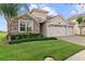 Two-story house with three-car garage and stone exterior at 1142 Trappers Trail Loop, Davenport, FL 33896