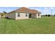 Backyard with covered patio and lawn at 1142 Trappers Trail Loop, Davenport, FL 33896