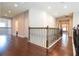 Upstairs hallway with hardwood floors and wrought-iron railing at 11848 Aldendale St, Orlando, FL 32836