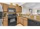 Well-equipped kitchen with black appliances at 12843 Madison Pointe Cir # 107, Orlando, FL 32821