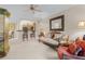 Bright living room features a comfy sofa and kitchen view at 12843 Madison Pointe Cir # 107, Orlando, FL 32821