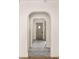 Long hallway with arched doorways and a diamond patterned floor at 1781 Goodrich Ave, Winter Park, FL 32789