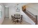 Elegant dining room with a round table, chandelier, and nearby staircase at 2277 Derwent Dr, Davenport, FL 33896