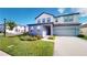 Two-story home with gray siding and a two car garage at 2277 Derwent Dr, Davenport, FL 33896