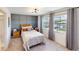 Bright bedroom featuring a wood bed frame and gray accent wall at 2277 Derwent Dr, Davenport, FL 33896