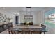 Bright dining room featuring a large table and modern chandelier at 2277 Derwent Dr, Davenport, FL 33896