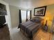 Bright bedroom with a comfortable bed and large window at 2520 Woodgate Blvd # 202, Orlando, FL 32822