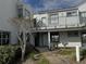 Exterior view of condo building with walkway and landscaping at 2520 Woodgate Blvd # 202, Orlando, FL 32822
