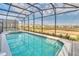 Inviting screened-in pool and spa with open view at 3032 Mahalo Dr, Davenport, FL 33897