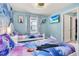 Another charming bedroom with Frozen-themed bedding and a wall mural at 3032 Mahalo Dr, Davenport, FL 33897