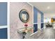 Elegant entryway with geometric wallpaper and a statement mirror at 3032 Mahalo Dr, Davenport, FL 33897