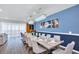 Elegant dining room with a long table and modern chandelier at 3032 Mahalo Dr, Davenport, FL 33897
