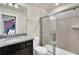 Bathroom with a walk-in shower and granite countertop vanity at 3032 Mahalo Dr, Davenport, FL 33897