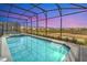 Relaxing pool and spa at sunset, screened-in at 3032 Mahalo Dr, Davenport, FL 33897