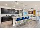 Modern kitchen with dark cabinets and granite countertops at 3032 Mahalo Dr, Davenport, FL 33897