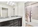 Bathroom with granite countertop double vanity and shower/tub combo at 3032 Mahalo Dr, Davenport, FL 33897