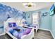 Charming bedroom with Frozen-themed bedding and a wall mural at 3032 Mahalo Dr, Davenport, FL 33897