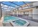 Enjoy this screened pool and spa with patio at 3032 Mahalo Dr, Davenport, FL 33897