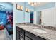 Bathroom with granite countertop, double sinks, and a view of a bedroom at 3032 Mahalo Dr, Davenport, FL 33897