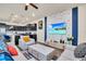 Bright living room featuring stylish furniture and a large TV at 3032 Mahalo Dr, Davenport, FL 33897