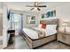 Main bedroom with wood bed frame and ceiling fan at 3032 Mahalo Dr, Davenport, FL 33897