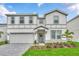Two-story home with gray siding and gray paved driveway at 3032 Mahalo Dr, Davenport, FL 33897