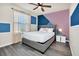 Bedroom with gray bed frame and accent wall at 3032 Mahalo Dr, Davenport, FL 33897